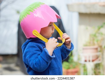 Cute Toddler Boy Pretending To Be A Football Player With An Easter Basket For A Helmet