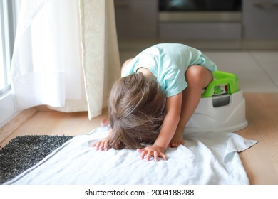 Cute Toddler Boy Sitting And Looking Under Chamber Pot, Potty Training Hygiene. Mixed Race Asian-German Baby  Sit On Toilet Wc Seat At Home.