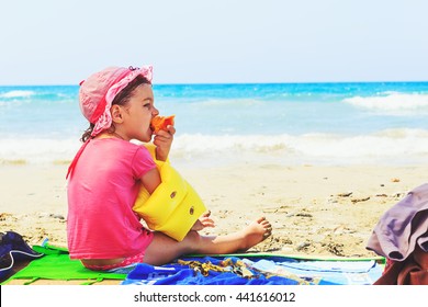 Cute Toddler Eating Fresh Summer Peach  On The Beach 