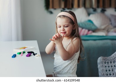 Cute Toddler Girl Playing With Plasticine Or Play Dough At Home. Child Learning To Work With Modelling Clay. Education Concept