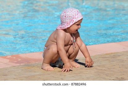 Cute toddler girl playing in a swimming pool
