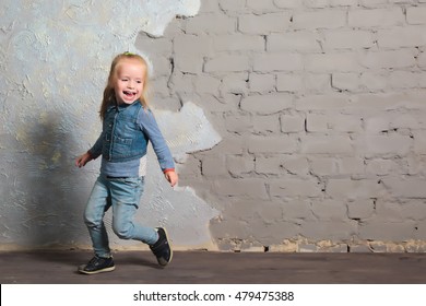 Cute Toddler Girl Posing Joyfully To Camera. Dancing, Jumping, Running, Laughing. Vintage Background. Happy Childhood, Beautiful Baby. Denim Clothes.