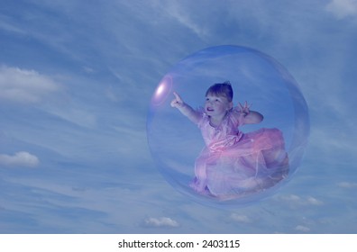 cute toddler girl in princess dress floating in a bubble.