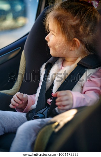 cute toddler girl sitting in the car seat-\
Safety and\
security \
