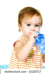 Cute Toddler Holding A Sippy Cup Drinking Water