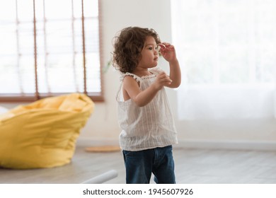 Cute Toddler Little Baby Girl With Curly Hair Running And Playing On Floor At Home