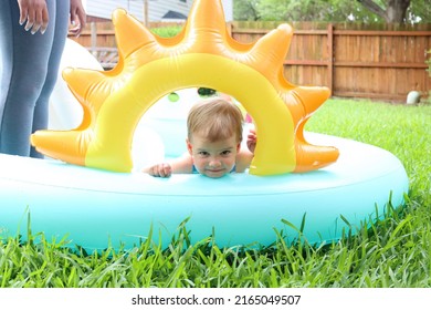 Cute Toddler Playing In Backyard Swimming Pool