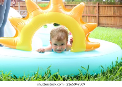 Cute Toddler Playing In Backyard Swimming Pool