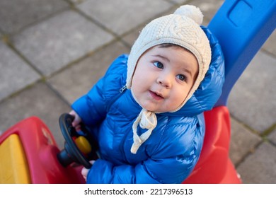 Cute Toddler Is Riding His Toy Scooter And Push Car In The Back Yard