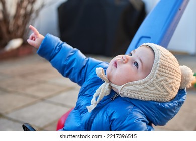 Cute Toddler Is Riding His Toy Scooter And Push Car In The Back Yard