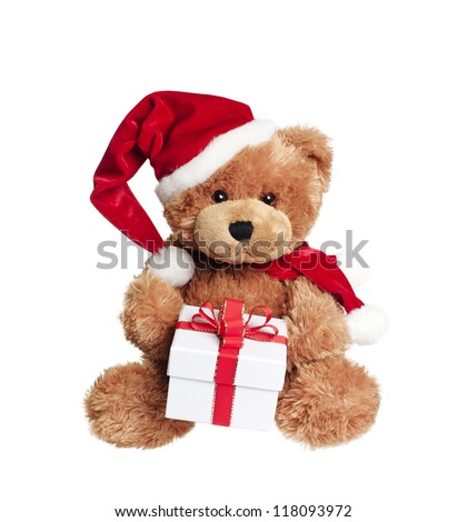 Cute toy bear with christmas gift and santa hat on white background