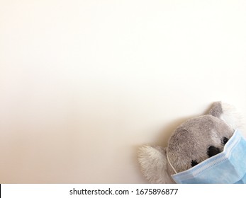 A Cute Toy Koala Wear A Blue Surgical Face Mask Isolated On White Background. Disposable Face Mask (with Clipping Path).