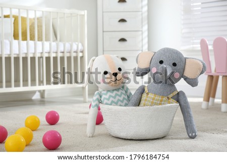 Cute toys on floor in baby room. Interior elements