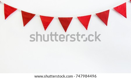 Cute triangle bunting flag red, white, black color polka dot, plaid, striped pattern design hanging for party decorated on wall room with copy space for text.birthday or festival concept