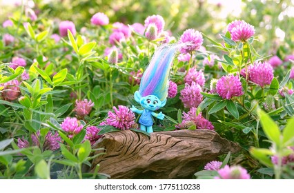 cute troll on summer floral meadow, natural background. Harper Pinsel - modern popular toy hasbro trolls. concept of children's games, fun, toys, friendship, holiday, happiness