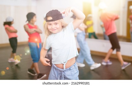 Cute Tween Girl Hip Hop Dancer Posing During Workout In Group Dance Class For Children..