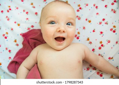 A cute two month old baby in bed at home