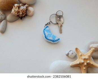 Cute and unique beading key chain on a white background. Bead colorful key chain and stones