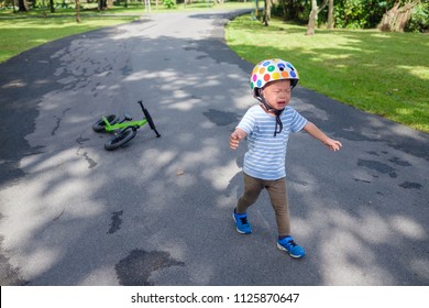 Cute Upset Stress Sad Unhappy Little Asian 2 Years Old Toddler Baby Boy Child Crying After Fallen From His First Bicycle / Balance Bike, Toddler's Terrible Twos And A Child's Tantrum In Public Concept