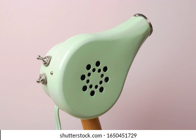 Cute Vintage Blow Dryer On Rose Colour Background. Styling Tool From The 1950's Or 1960's. Heat Blower For Drying And Styling. Minimal Concept With Muted Colours. Self Care Grooming Tools. Copy Space.