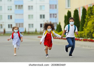 Cute White And Black Students In Face Mask For Prevention Corona Virus Or Flu Are Running Back To School .