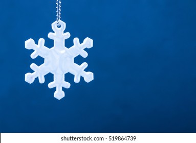 Cute White Safety Reflector In The Form Of Snowflakes On Blue Background. Necessary Equipment To Pedestrians For Walks During Dark Conditions.