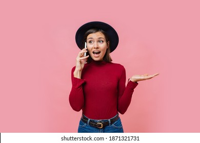 Cute White Woman Talking By Mobile Phone With Suprice Face Over Pink Background. 