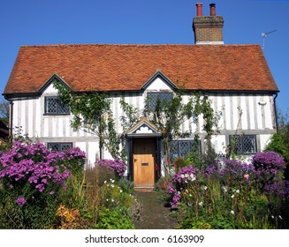 Cute Whitewashed Timbered Medieval Cottage In A Rural English Village