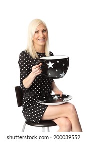 Cute Woman With A Black Spotted Dress Holding An Oversized Coffee Cup. White Background.