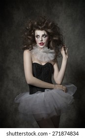 Cute Woman With Crazy  Hair Style Posing With Clown Make-up And Vintage Tutu. Bizzarre Romantic Masquerade 