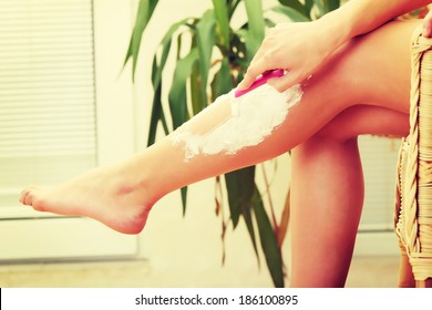 Cute Woman Shaving Her Legs At Home