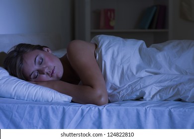 Cute Woman Sleeping At Night In The Bedroom