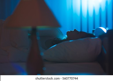 The Cute Woman Sleeping On The Bed. Evening Night Time