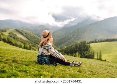 Cute woman walking green grass field, admiring landscape. Enjoying nature alone. Adventure and travel.  - Powered by Shutterstock