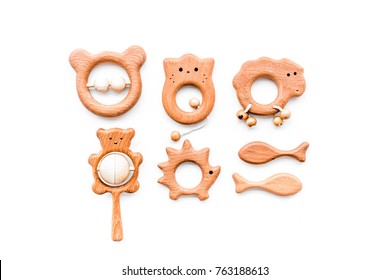 Cute Wooden Handmade Toys For Newborn On White Background Top View