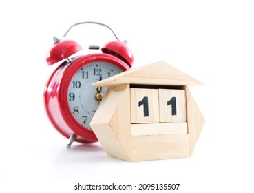 Cute Wooden Small Desk Calendar And Alarm Clock On White Background