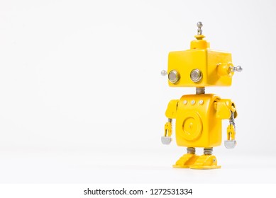 Cute, yellow, handmade robot on a white background.