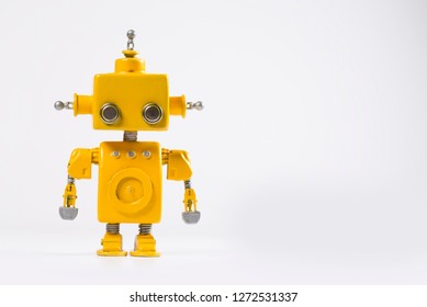 Cute, yellow, handmade robot on a white background.