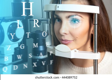 Cute young adult brunette woman at the future clinic checks her vision. Virtual sensors for checking vision. Ophthalmology. Future medicine and health concept.