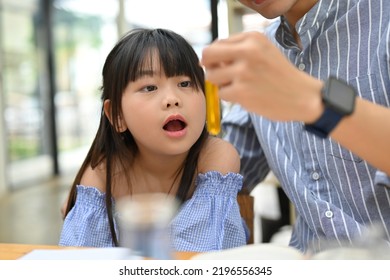 Cute Young Asian Girl Excited And Amazed While Her Science Teacher Showing A Special Liquid In Test Tube. Kid With Science Experiment Concept