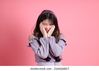 The cute young Asian woman with preppy dressed standing on the pink background. - Shutterstock ID 2164266817