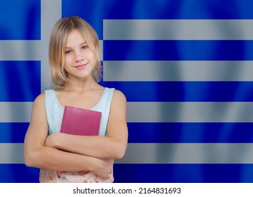 Cute Young Blonde Teen Girl Child Holding Book Against Flag Of Greece Background. Education And School In Greece Concept