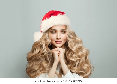 Cute young blonde woman in Santa hat, Beauty Christmas portrait - Powered by Shutterstock