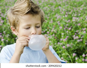 Cute Young Boy Blowing Bubble Gum