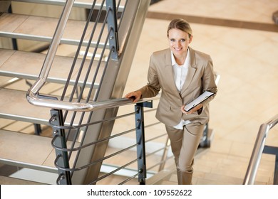 cute young businesswoman walking up stairs
