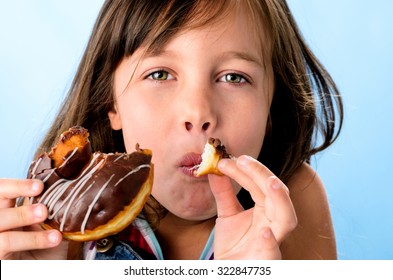 Cute Young Caucasian Girl Caught Eating A Chocolate Doughnut