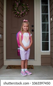 Cute Young Caucasian Girl Child Stands On Front Porch For Photo Before First Day Of School