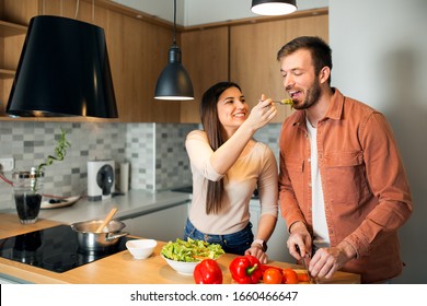 Cute young couple cooking together in kitchen 