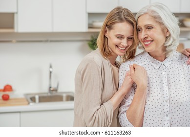Cute young daughter embracing her mother with love - Shutterstock ID 611163263