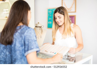 Cute Young Female Salesperson Showing Some Necklaces To A Customer At A Jewelry Store